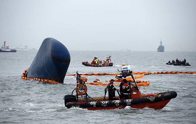 Rescue boats sail around the South Korean passenger ship Sewol which sank, during their rescue operation in the sea off Jindo