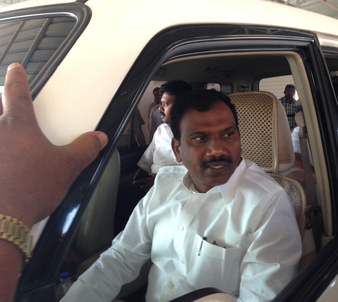 A Raja speaks to DMK volunteers before heading out for another campaign rally.
