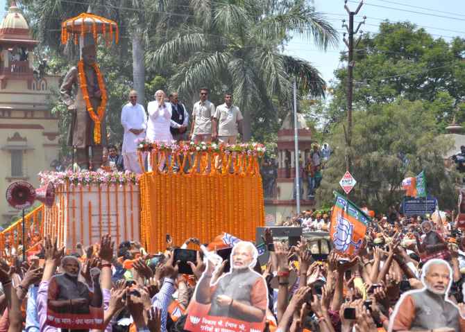 Narendra Modi greets supporters in Varanasi on Thursday