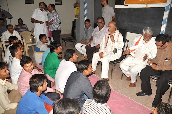 VHP General Secretary Kiritbhai Mistry (standing, left, in a white outfit) and S D Jani (extreme right, in brown shirt) and VHP International Working President Pravin Togadia at a meeting on the night of April 19.