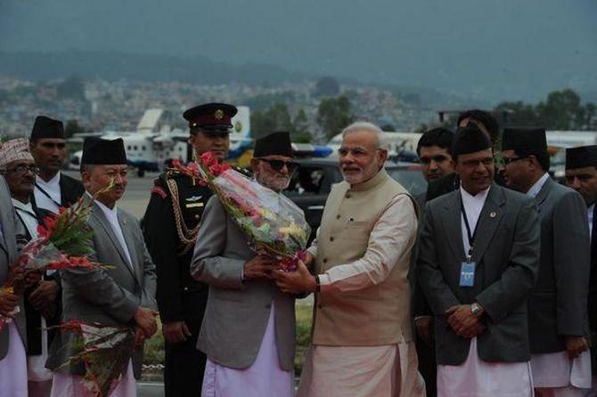 PM Modi is warmly welcomed by Nepal PM Sushil Koirala at the Tribhuvan International Airport.