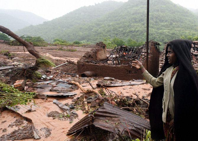 Relative of a landslide victim at Malin village in Pune, Maharashtra reacts after she loses her home and family