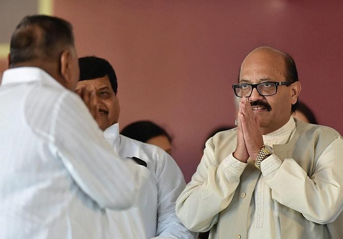 Samajwadi Party President Mulayam Singh Yadav exchanges greetings with partys expelled leader Amar Singh at the inauguration of Janeshwar Misra Park in Lucknow on Tuesday