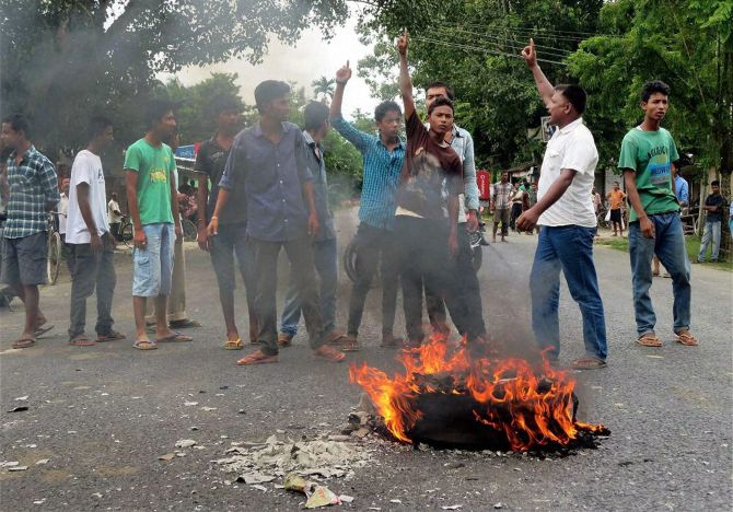 Protestors blocking the National Highway road against the killing of Assamese people by NSCN at Assam Nagaland border in Golaghat.