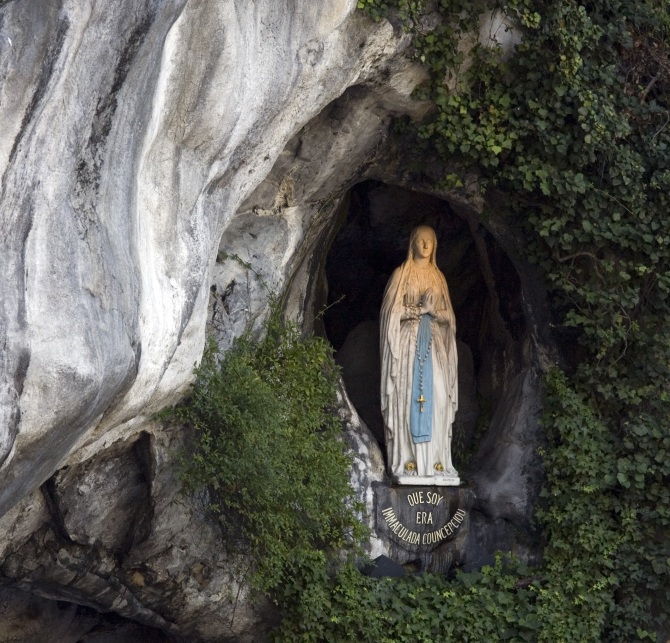 The Statue of Our Lady of Lourdes at the entrance to the Grotto of Massabielle in Lourdes. 