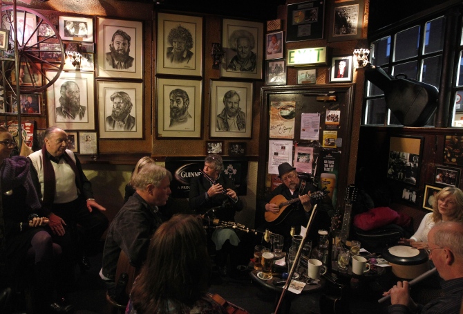 Musicians play Irish traditional music in a pub in central. 