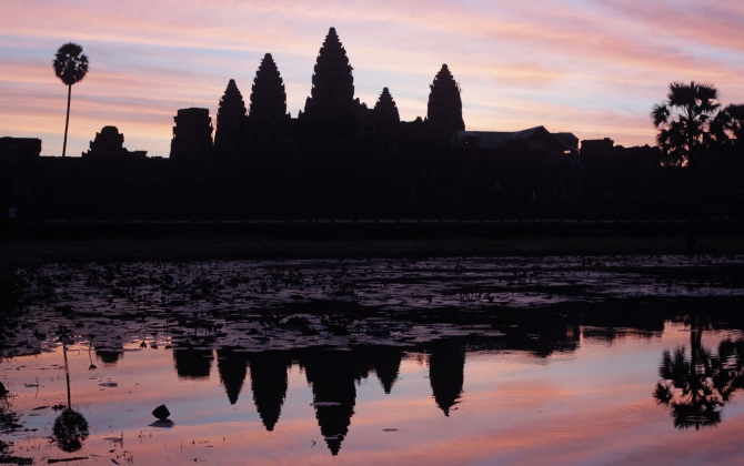 Cambodia's famous Angkor Wat temple is reflected in a pond during sunrise in Siem Reap.