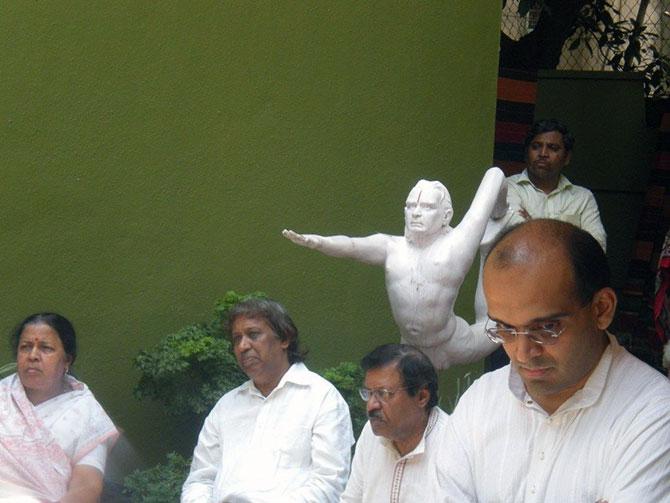 Yoga practitioners, teachers and others gather at BKS Iyengar's yoga institute in Pune on Wednesday to pay their last respects.