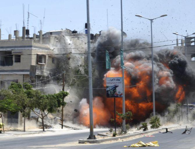 An explosion caused by an Israeli air strike on a house in Gaza City. 