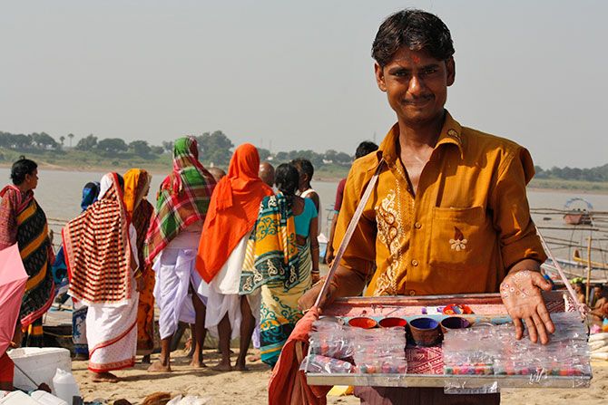 A bindi seller shows off his wares