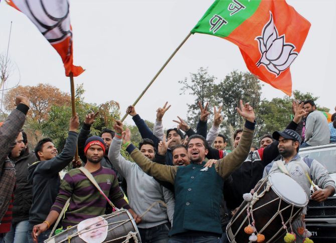 BJP workers celebrate after the election results in Jammu on Tuesday, December 23. Photograph: PTI