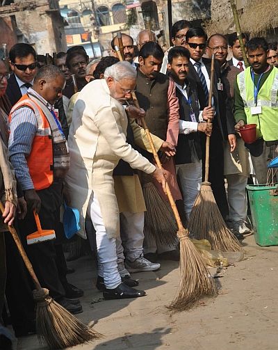 Prime Minister Narendra Modi sweeps a street in Varanasi
