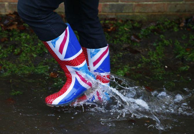 A resident's Wellington boots are seen splashing through water after the river Thames flooded the village of Wraysbury, southern England 