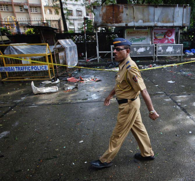 A policeman walks past the site of an explosion at Dadar in Mumbai 