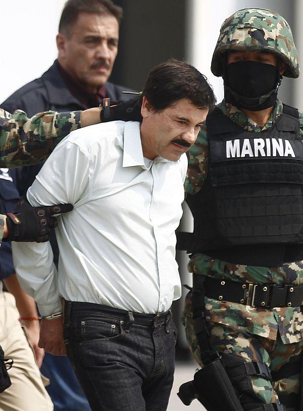 Joaquin Shorty Guzman is escorted by soldiers during a presentation at the Navy's airstrip in Mexico City