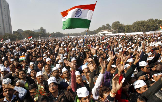 Aam Aadmi Party supporters listen to Chief Minister Arvind Kejriwal in New Delhi.
