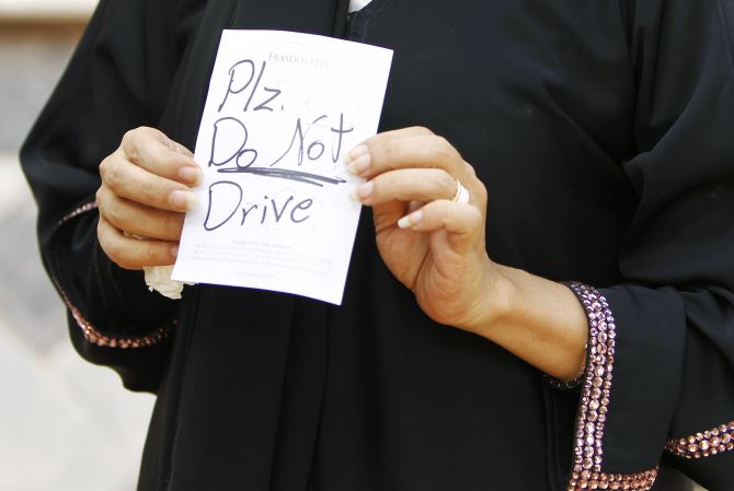 A female driver displays a note which was placed on her car in Saudi Arabia, a nation where women can't legally drive.