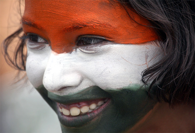 A school girl with her face painted in the colours of the national flag in Chandigarh.