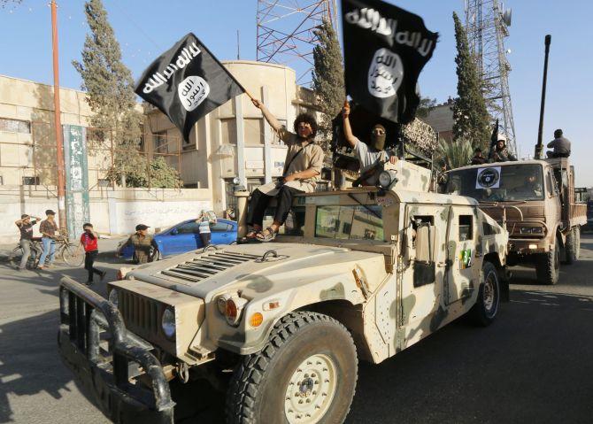 Militant Islamist fighters take part in a military parade along the streets of Iraq after declaring the parts they control as an Islamic State.