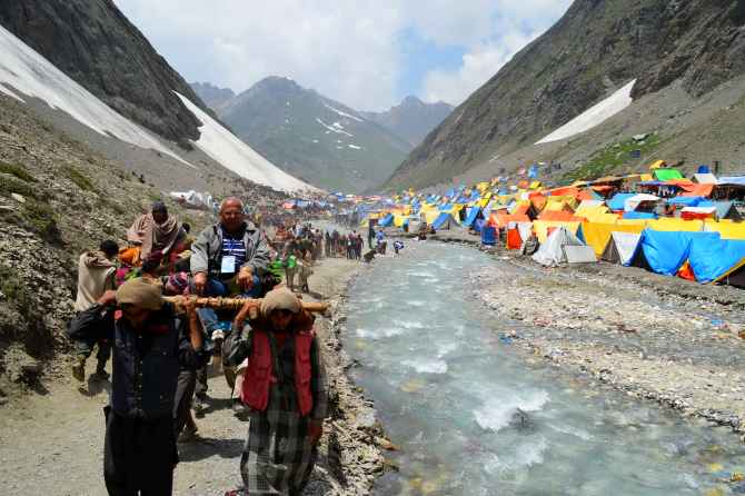 Pilgrims proceed towards the Holy Amarnath shrine from Baltel route on Saturday