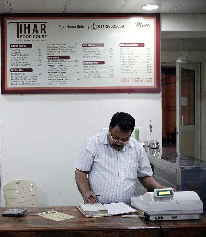 Kishan Singh Bisht, a jail warden in Tihar, maintains a register inside a restaurant run by the Tihar Jail authorities on Jail Road in west Delhi
