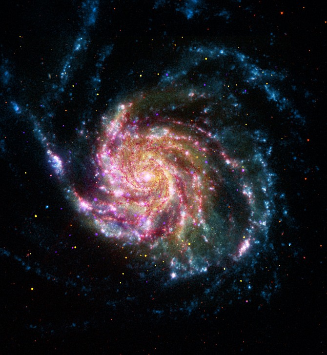 This image of the Pinwheel Galaxy, or also known as M101, combines data in the infrared, visible, ultraviolet and X-rays from four of NASA's space-based telescopes. This multi-spectral view shows that both young and old stars are evenly distributed along M101's tightly-wound spiral arms. Such composite images allow astronomers to see how features in one part of the spectrum match up with those seen in other parts. It is like seeing with a regular camera, an ultraviolet camera, night-vision goggles and X-ray vision, all at the same time.