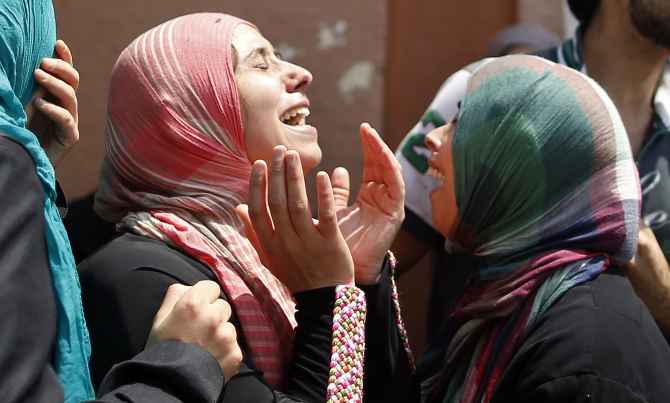 Palestinian women mourn the loss of a child killed in Israeli shelling in Gaza City.