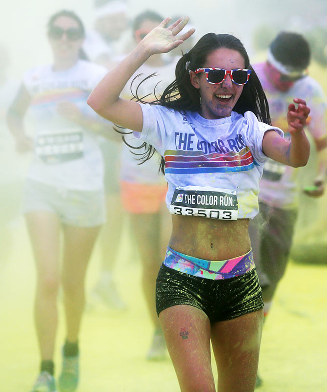 Participants are covered in paint as they take part in the Colour Run in London on June 1.