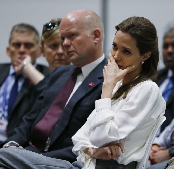 Jolie turns emotional as she hears a speech from one of the victims at the conference.