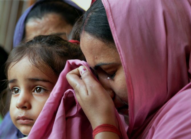 Reena Choudhary, wife of Rajesh Kumar who is trapped in Iraq, weeps