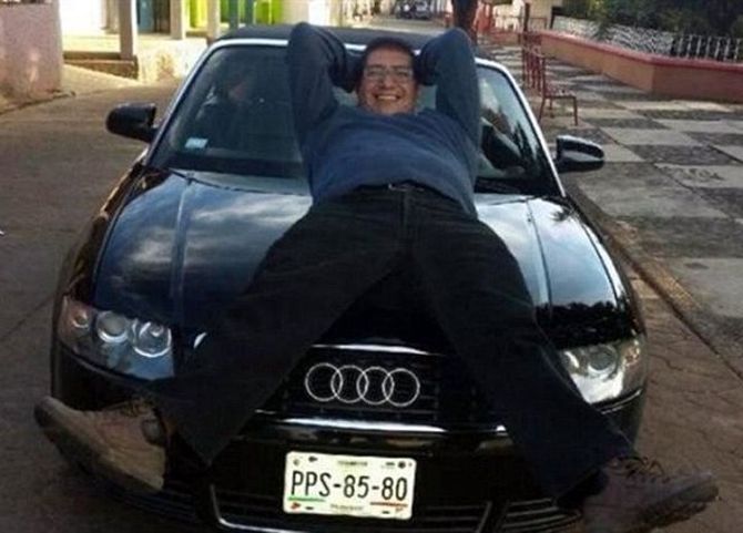 Father Jorge Manuel Guevara Corona poses with his Audi