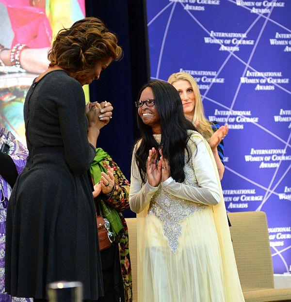 US First Lady Michelle Obama honors 2014 International Women of Courage Awardee Laxmi, a Campaigner for Stop Acid Attacks in India, at the 2014 Secretary of State's International Women of Courage Award Ceremony