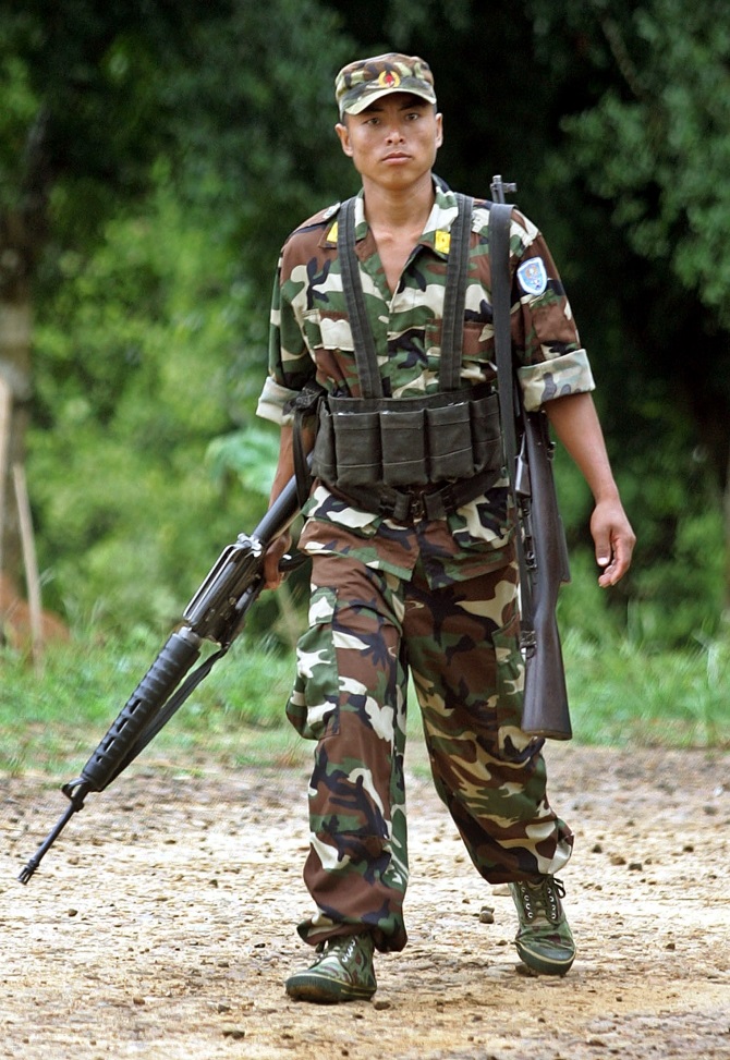 A Naga rebel patrols the inside of Hebron Camp in Nagaland. Rebels from the hill tribes of Nagaland fought a fierce insurgency against India for five decades until a ceasefire in 1997