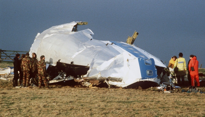 Scottish rescue workers and crash investigators search the area around the cockpit of Pan Am flight 103 in a farmer's field east of Lockerbie, Scotland.