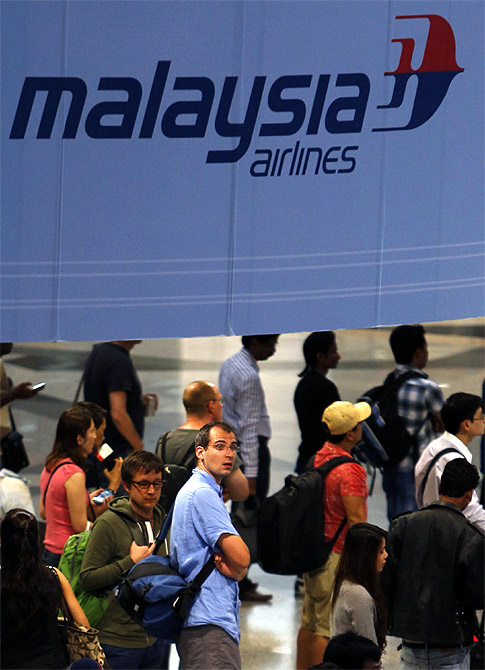 Passengers queue up for customs checks at the Kuala Lumpur International Airport in Sepang