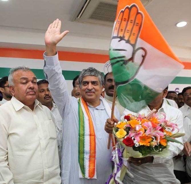 Nilekani waves to his supporters as he is officially inducted in Congress on Sunday