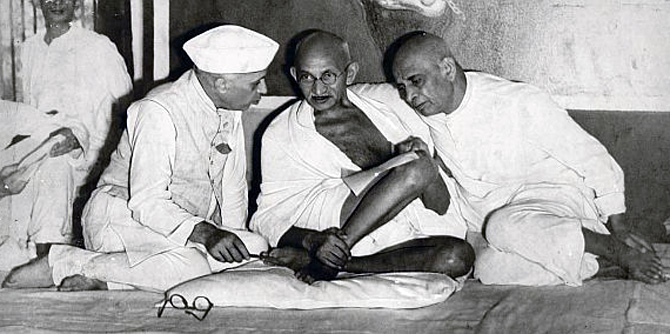 Mahatma Gandhi flanked by Jawaharlal Nehru and Vallabhbhai Patel.