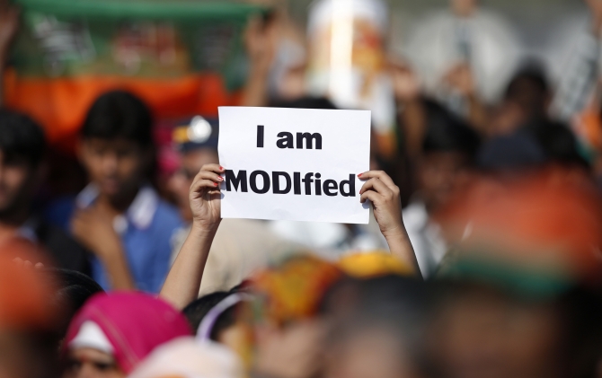 A Modi supporter holds a placard during a rally in Mumbai.