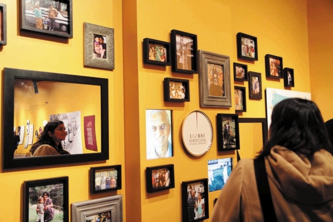 A wall of family photographs showing the diversity of the community.