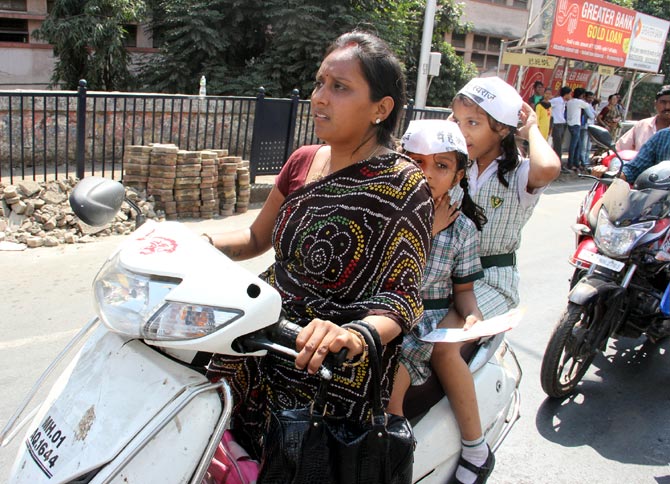 A mother with her two young daughters follow his convoy in Mumbai.