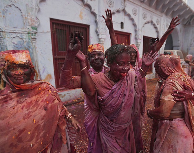 Widows dance as they take part in Holi celebrations at the ashram