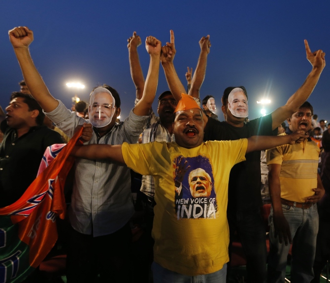 Supporters of Hindu nationalist Narendra Modi, prime ministerial candidate for the Bharatiya Janata Party and Gujarat's chief minister, cheer before the start of a rally
