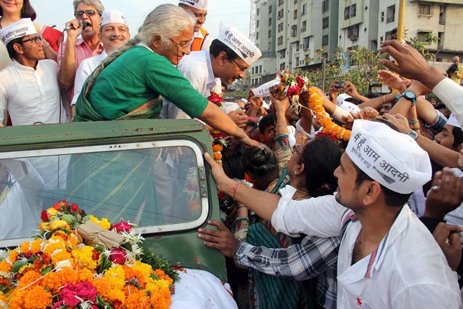 Medha Patkar greets supporters along with AAP leader Arvind Kejriwal during the latter's recent visit to Mumbai.