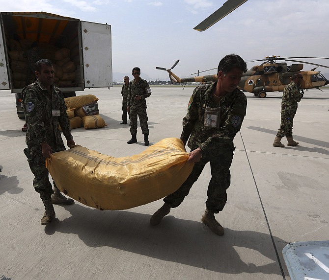 Afghan National Army troops load supply for survivors of the Badakhshan landslide onto a helicopter in Kabul