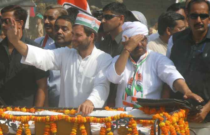 Rahul Gandhi and Congress candidate Ajai Rai wave to supporters during a roadshow in Varanasi on Saturday
