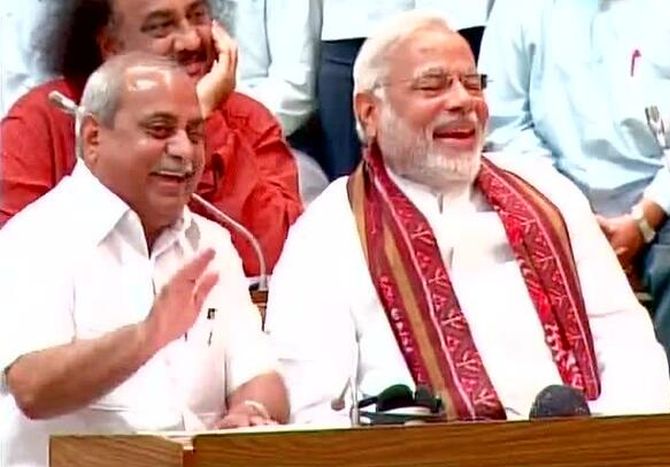 Narendra Modi and Nitin Patel laugh as Gujarat speaker Vajubhai Vala speaks during Modi's farewell session