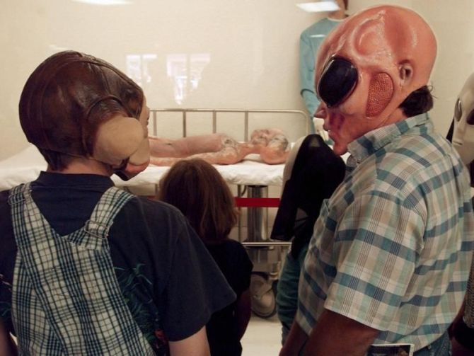 Tourists wearing the alien masks at the Roswell museum.