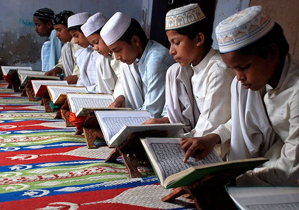 Muslim children read the Quran at a madrasa.