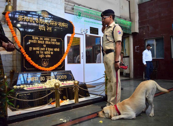 A police officer pays his respects in 2014 at the 26/11 memorial at the CST station, which terrorists attacked that horrific night. Photograph: Sahil Salvi