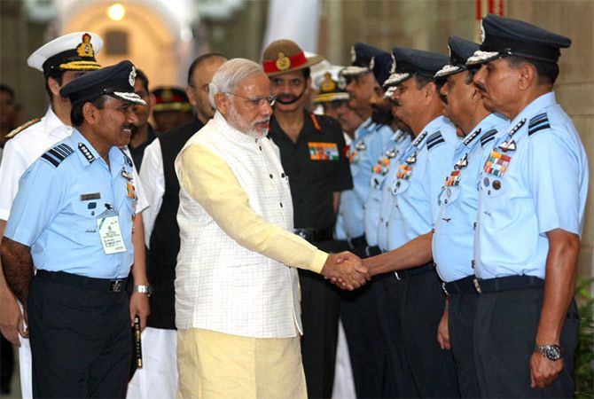 Air Chief Marshal Arunp Raha introduces Prime Minister Modi to air force commanders.